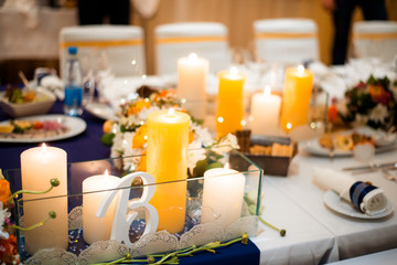 Festive table setting with a bouquet of flowers and candles.