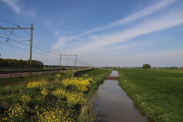 Fototapeta na wymiar Double railroad track between Gouda and Rotterdam at Moordrecht in the Zuidplaspolder, the lowest area of western Europe