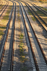 Fototapeta premium Rusty railroad tracks on gravel. Top view.