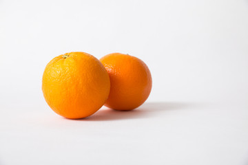 Whole orange fruits isolated on white background. Side view, closeup. Natural vitamin or organic food concept