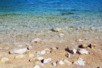 Majestic nature background. White pebble beach, crystal clear seawater and gradient turquoise and blue color tone of water