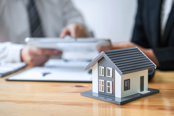 Estate agent are presenting home loan and giving house to client after discussing and signing agreement contract with approved application form, Home Insurance and Real estate investment concept