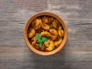 King Prawn Masala in a clay bowl. Traditional Indian cuisine