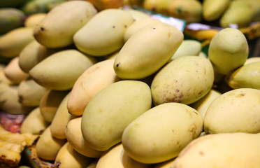 Mango on the counter in the market .