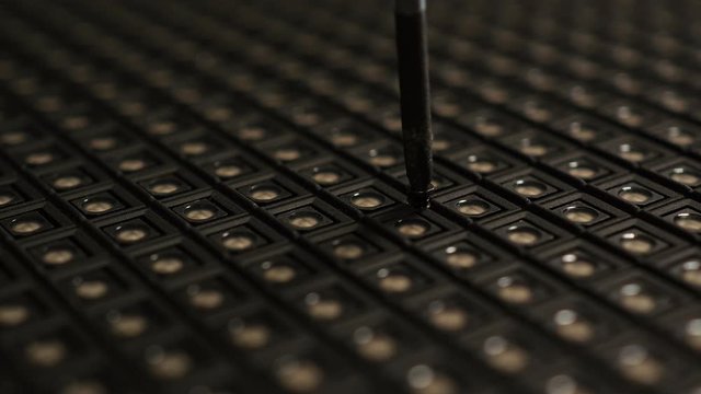 Manually unscrewing and removing screw with hand and screwdriver.