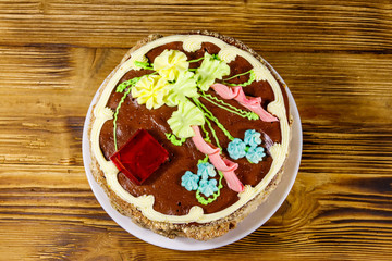 Kiev cake with cream, nuts and meringue on wooden table. Top view