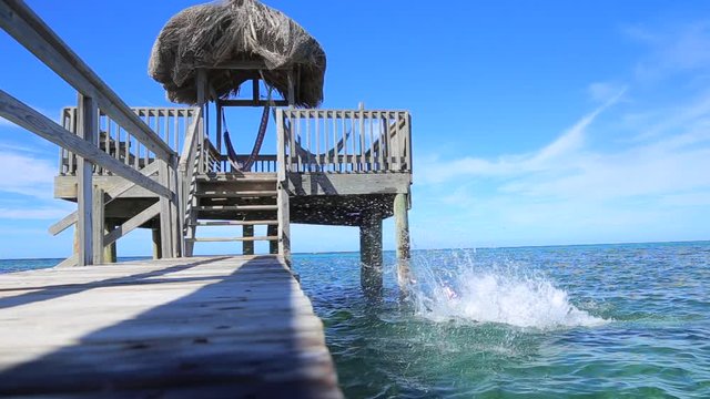 A young tourist boy bathing on the beach at Sandy Bay, Roatan Island. Honduras