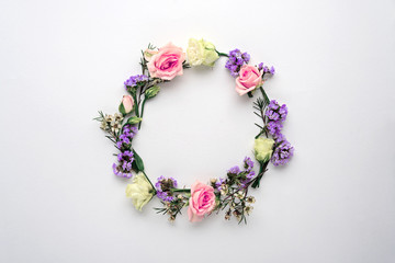 flower circle, frame on white background, composition of roses, limonium, eustoma with copy space, flat lay, top view