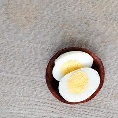 halves of boiled eggs on wooden rustic background. the view from the top
