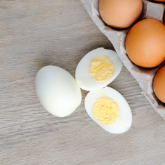 halves of boiled eggs on wooden rustic background. the view from the top

