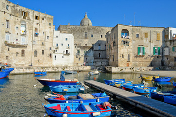 Boats in the ancient port of the old town of Monopoli, Italy

