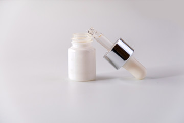 White cosmetic skincare dropper bottle packaging on white background