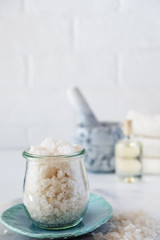  Glass jar of big crystals see salt. Healthy skin care. SPA concept
