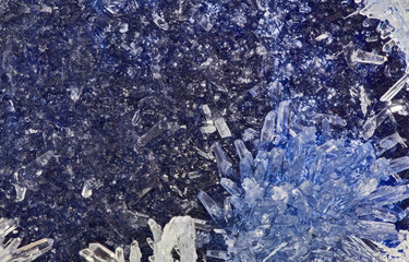 blue and white small crystals on dark background