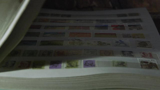 Opening a page of a stamp collecting album.