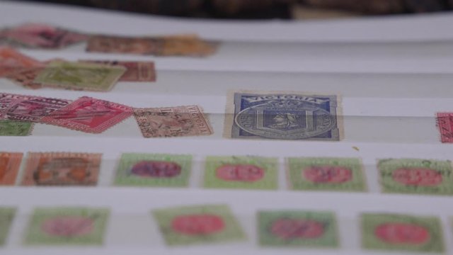 Pan over stamps in a stamp collectors album.