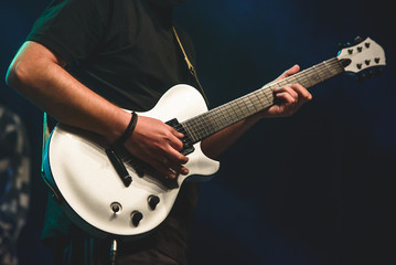 Guitar player on stage playing instrument