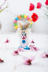 Easter bunny with eggs on a white wooden background
