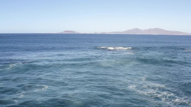 Ocean Waves Splash on Cliffs at Corralejo Fuerteventura shot with Aerial Drone