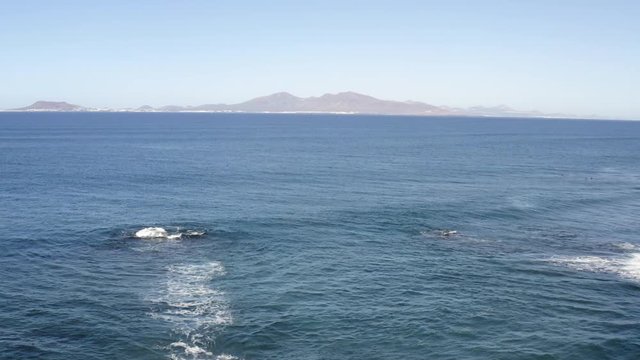 Water Waves Splash against Cliffs on Corralejo Fuerteventura shot with Aerial Drone