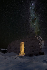 Old ruin at night with a sky full of stars in the desert