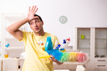 Young male contractor doing housework at home