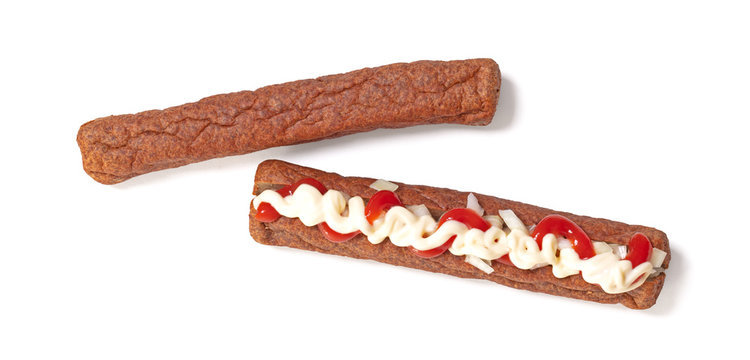 One frikadel with ketchup, mayonnaise on chopped onions, a Dutch fast food snack called 'frikadel speciaal'