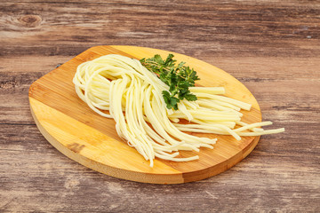 Chechil spaghetti cheese over board