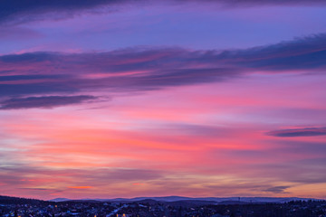 Beautiful red-blue, purple sunset over the night city. Bright orange sunset over the city...
