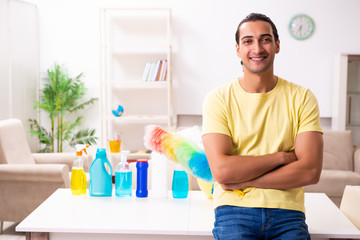 Young male contractor doing housework at home