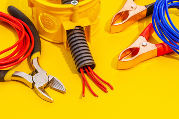 Spare parts, tools and wires for replacement or repair of electrical equipment on yellow background