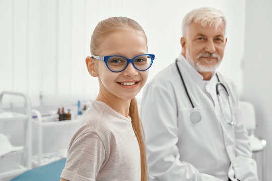 Young Patient And Eldery Doctor On Couch.