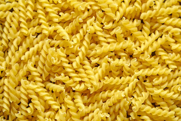 Pasta italian spiral background, uncooked dry pasta