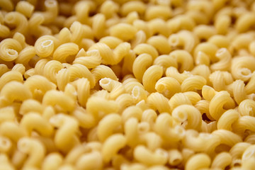 Pasta Cavatappi, closeup, selective focus. Uncooked durum wheat pasta