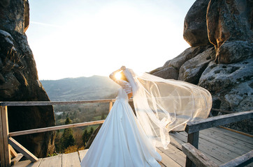 wedding day. The bride dances in the rays of the setting sun.The bride's veil is blown by the wind....