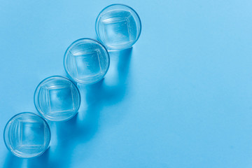 Water filters. Carbon cartridges and glasses on a blue background. Household filtration system.