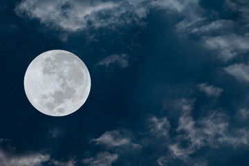 Fototapeta na wymiar Full moon and white clouds on the sky.