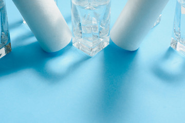 Water filters. Carbon cartridges and glasses on a blue background. Household filtration system.