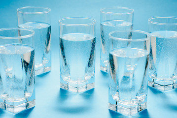 glasses with water on blue background. clean water concept