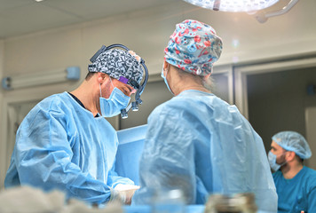 doctor performs plastic surgery