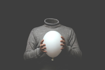 surreal man without head holding white balloon