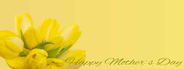Happy Mother's Day background  - Bouquet of yellow tulips and green lettering isolated on yellow paper texture, with space for text
