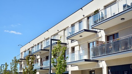 Obraz premium Residential Building on sky background. Facade of a modern housing construction with of balconies.