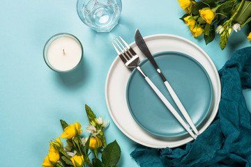 Spring table setting with flower top view.