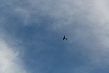 small plane flying low in the sky with space for text
