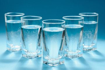 glasses with water on blue background. clean water concept