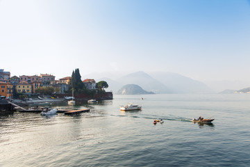view of Como Lake or Lago di Como with boats in summer. Popular tourist attraction in Lombardy, Northern Italy.
