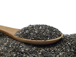 Chia seeds on wooden spoon isolated on white background.Chia grains that can be eaten to reduce weight well and high in protein and phosphorus,high in fiber and low calories.clean food and superfood