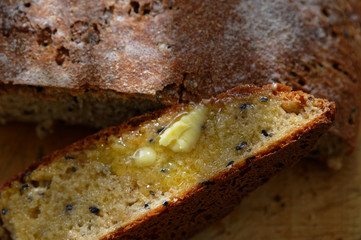 A slice of freshly baked bread with butter melting on it