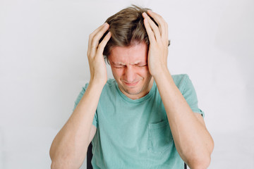 man having a headache and standing over white background